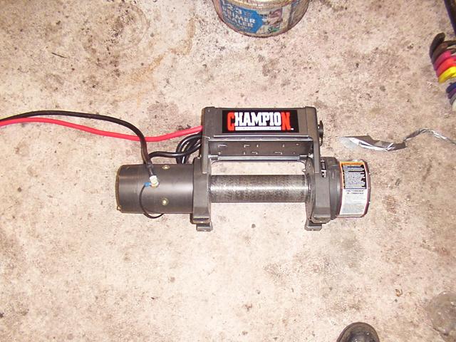 Broken CostCo/Champion 8k winch - look at the left corner, above the drum, below Champion.