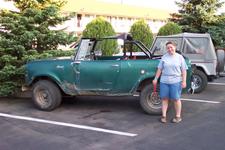 Michelle standing near her Scout - which, she points out, is still running and driving - in the hotel parking lot.