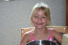 Carrie helps make brownies by licking the bowl