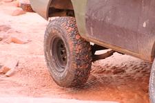 Stuck near the end of Bull Canyon, below Gemini Bridges - passenger rear tire is in the air, driver's is digging into the sand.