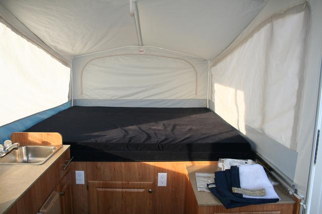 Looking towards the tongue / big bed.  Cabinet to the right (next to the door) is for the porta-potti